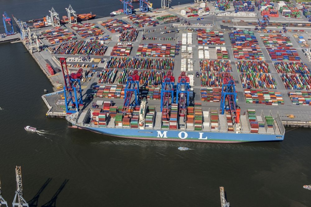 Aerial image Hamburg - View on container and container ships at berth HHLA Logistics Container Terminal Burchhardkai and Walter Hofer Euro Gate Container Terminal in the Port of Hamburg harbor in Hamburg. Containership MOL Triumph
