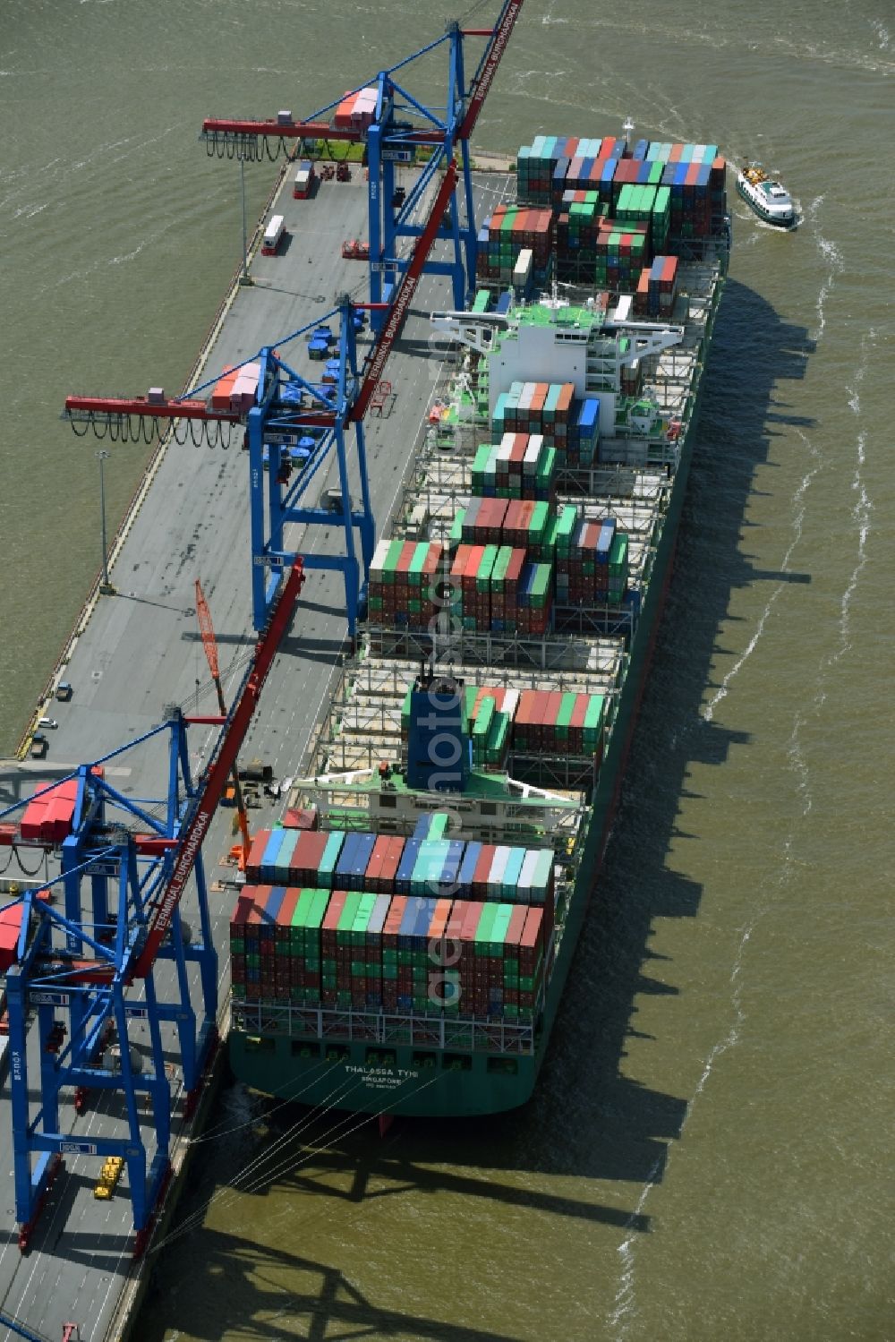 Aerial photograph Hamburg - View on container and container ships at berth HHLA Logistics Container Terminal Burchhardkai and Walter Hofer Euro Gate Container Terminal in the Port of Hamburg harbor in Hamburg. Containership MOL Triumph