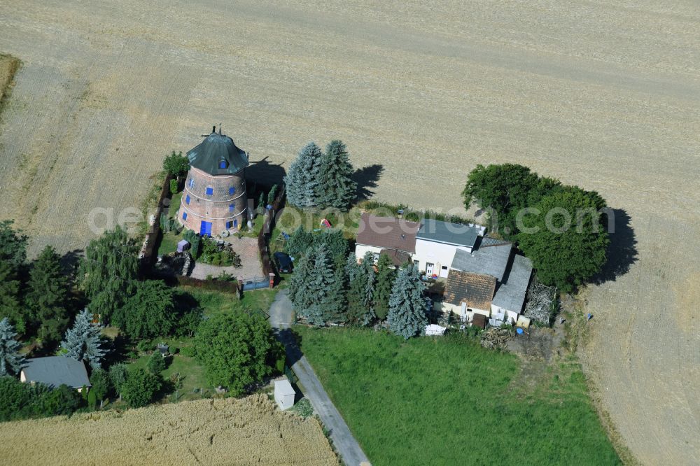 Naundorf from the bird's eye view: Historic windmill on a farm homestead on the edge of cultivated fields in Naundorf in the state Saxony