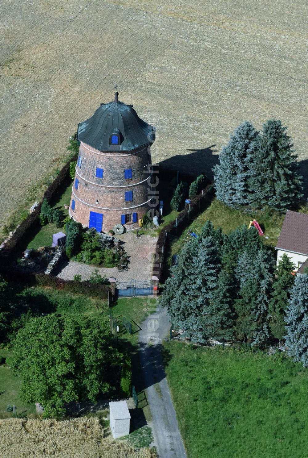 Naundorf from above - Historic windmill on a farm homestead on the edge of cultivated fields in Naundorf in the state Saxony