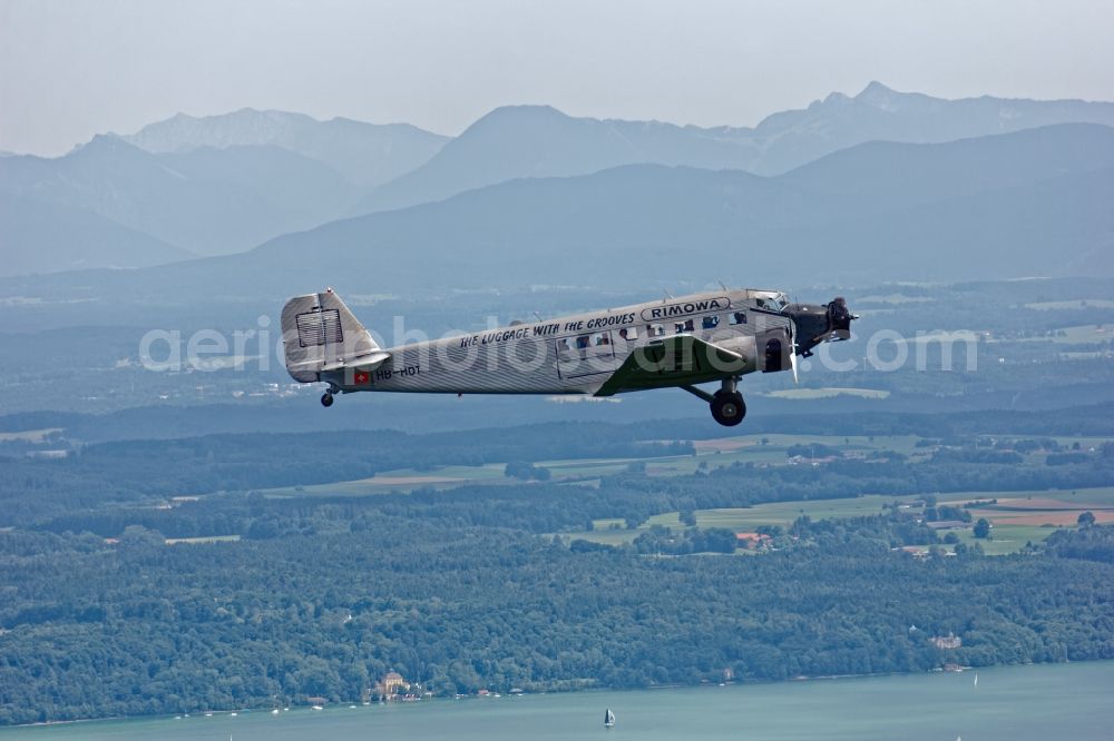 Starnberg from the bird's eye view: Historic aircraft Junkers Ju 52 on the fly over the airspace near Starnberg in the state Bavaria, Germany