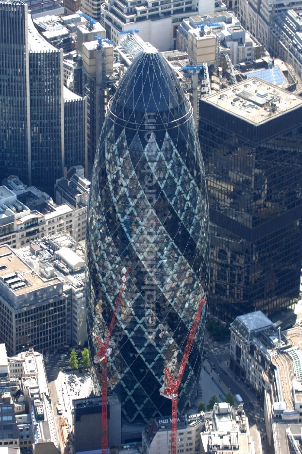 Aerial photograph London - High-rise St Mary Axe, The Gherkin often (English for pickle) or Swiss Re Tower called a skyscraper in the City of London financial district. It was established in 2001 to 2004 the architect Ken Shuttleworth and Lord Norman Foster at the site of the destroyed by an IRA attack Baltic Exchange and is an office tower of the reinsurer Swiss Re