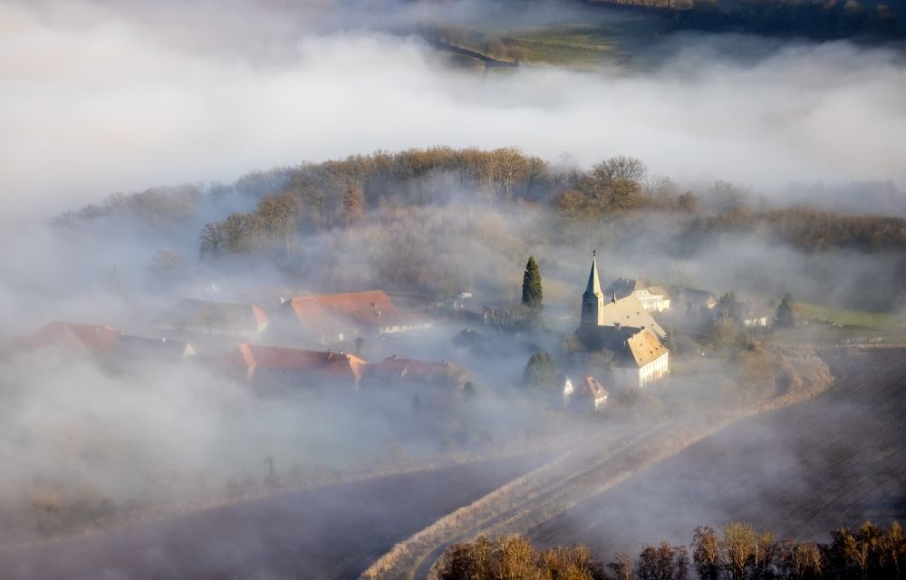 Arnsberg from the bird's eye view: Layer of fog and cloud over the building complex of the Oelinghausen monastery in the district of Holzen in Arnsberg in the state of North Rhine-Westphalia