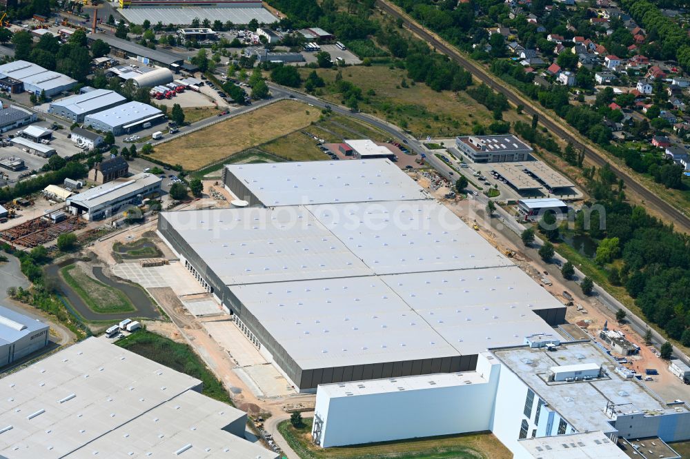Falkensee from the bird's eye view: High-bay warehouse building complex and logistics center on the premises of eCom Logistik GmbH on Strasse of Einheit in Falkensee in the state Brandenburg, Germany