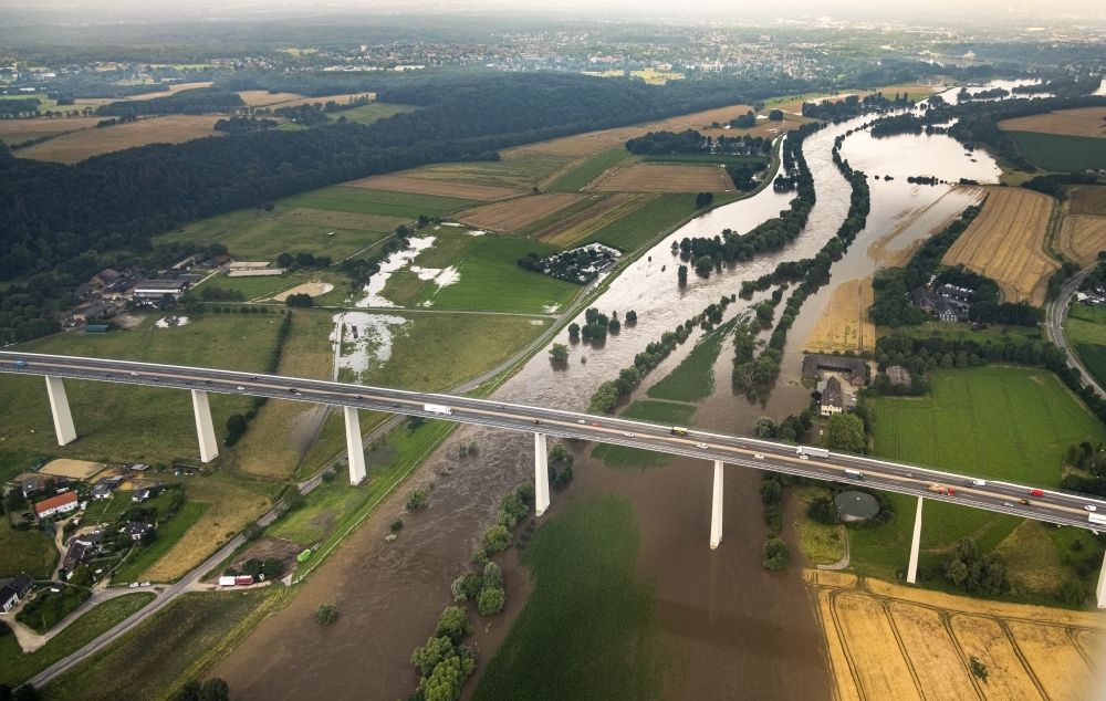 Mintard from above - Flooded Routing and traffic lanes over the highway bridge in the motorway A 52 over the shore of river Ruhr in Muelheim on the Ruhr in the state North Rhine-Westphalia, Germany