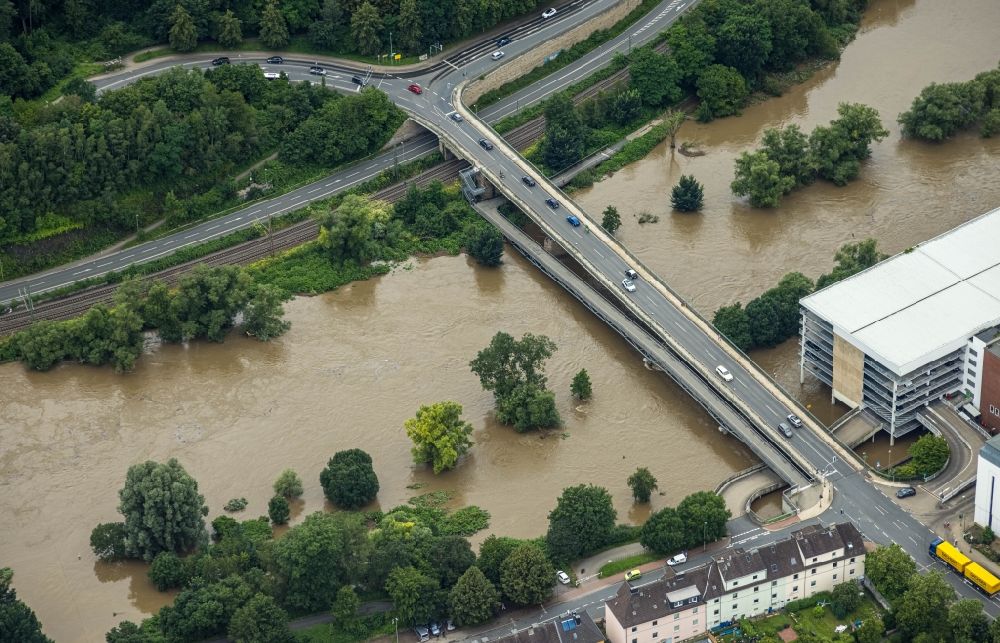 Wetter (Ruhr) from above - Flood situation and flooding, all-rousing and infrastructure-destroying masses of brown water on the bridge structure on Ruhrstrasse in Wetter (Ruhr) at Ruhrgebiet in the state North Rhine-Westphalia, Germany
