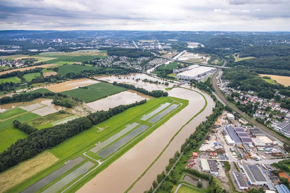 Schwerte from the bird's eye view: Flood situation and flooding, all-rousing and infrastructure-destroying masses of brown water along the Ruhr in Schwerte in the state North Rhine-Westphalia, Germany