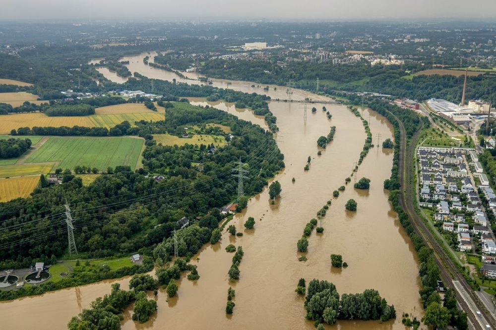 Aerial photograph Bochum - Flood situation and flooding, all-rousing and infrastructure-destroying masses of brown water on the course of the river Ruhr in the district Dahlhausen in Bochum at Ruhrgebiet in the state North Rhine-Westphalia, Germany