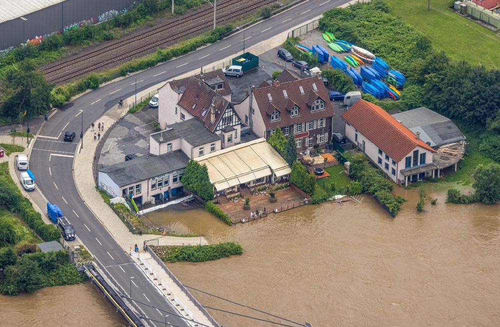 Essen from the bird's eye view: Flood situation and flooding, all-rousing and infrastructure-destroying masses of brown water on Kampmannbruecke in the district Kupferdreh in Essen at Ruhrgebiet in the state North Rhine-Westphalia, Germany