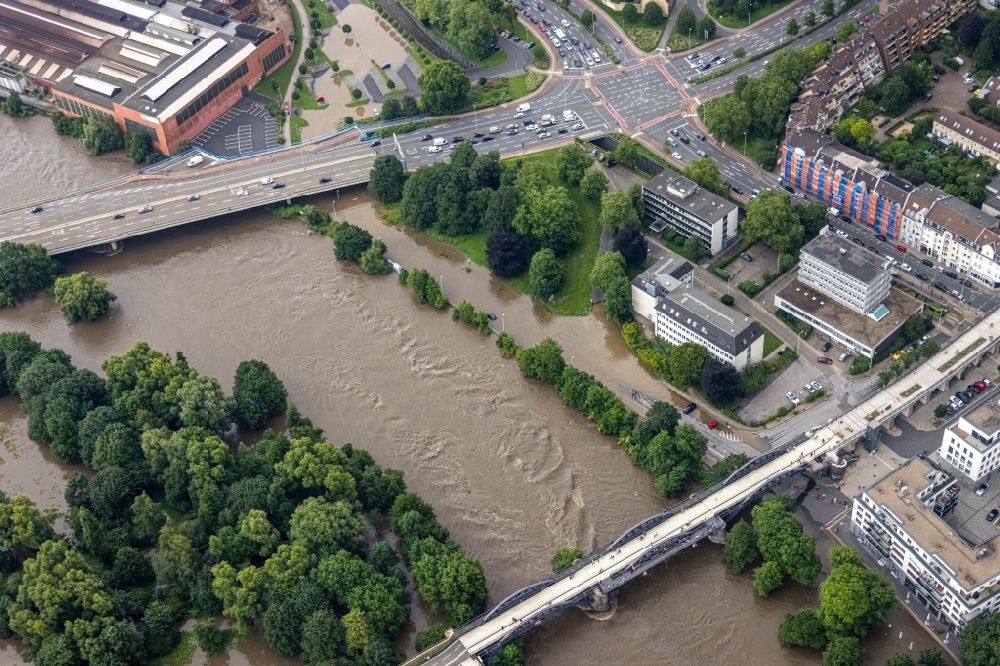 Mülheim an der Ruhr from the bird's eye view: Flood situation and flooding, all-rousing and infrastructure-destroying masses of brown water on the banks of the Ruhr in Muelheim on the Ruhr at Ruhrgebiet in the state North Rhine-Westphalia, Germany
