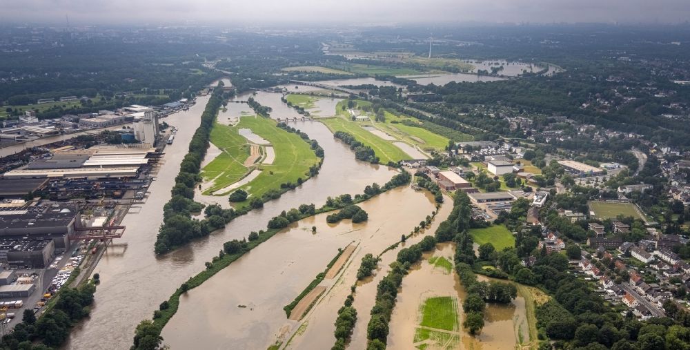 Mülheim an der Ruhr from the bird's eye view: Flood situation and flooding, all-rousing and infrastructure-destroying masses of brown water on the course of the Ruhr in Muelheim on the Ruhr at Ruhrgebiet in the state North Rhine-Westphalia, Germany