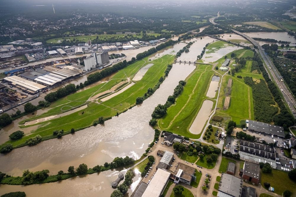 Mülheim an der Ruhr from above - Flood situation and flooding, all-rousing and infrastructure-destroying masses of brown water on the course of the Ruhr in Muelheim on the Ruhr at Ruhrgebiet in the state North Rhine-Westphalia, Germany