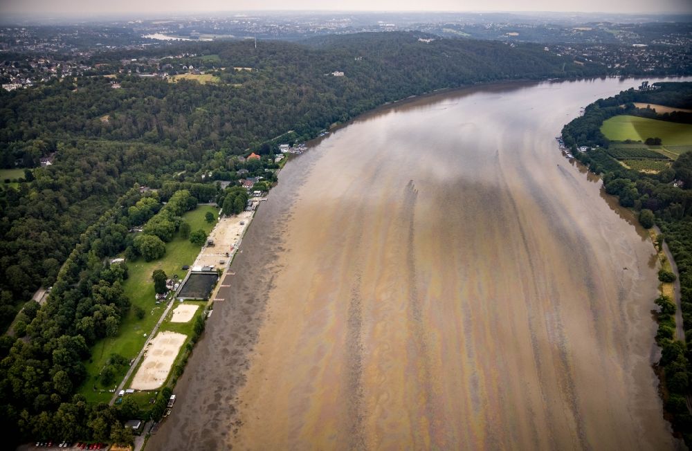 Essen from the bird's eye view: Flood situation of the inundating, all-moving and infrastructure-destroying brown water masses with extensive oil spill on the water surface of the Baldeneysee in the district Bredeney in Essen in the Ruhr area in the state North Rhine-Westphalia, Germany