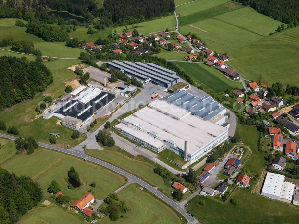 Freyung from the bird's eye view: Industrial and commercial area of Firmen Hirschmann Automotive GmbH, FM Textilhandels GmbH and the Max Fuchs AG in the district Speltenbach in Freyung in the state Bavaria, Germany