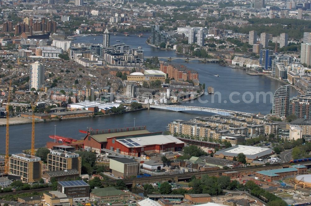 London from above - View at the inner city and the River Thames with Battersea Bridge, the railway bridge at the Harbour Street and Wandsworth Bridge in the district Wandsworth in London in the county of Greater London in the UK. You can see the city districts Wandsworth, Chelsea and Battersea