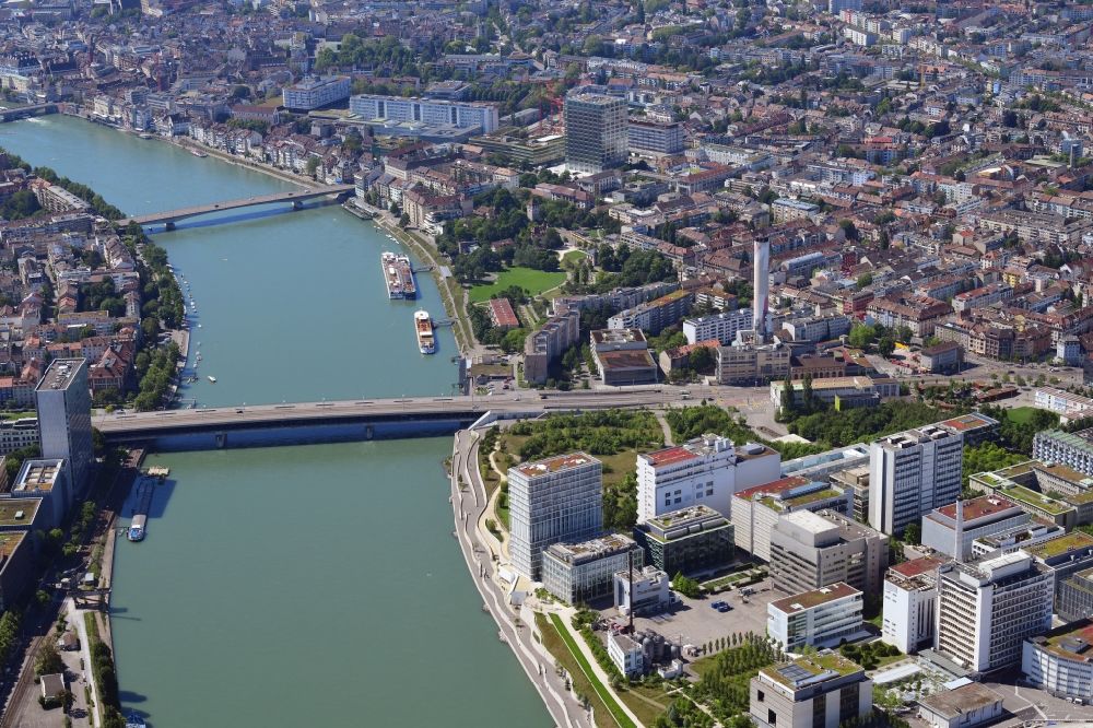 Aerial photograph Basel - Downtown area on the banks of river course Rhine at the Bridge Dreirosenbruecke next with buildings of the Pharma Global Player Novartis in Basel, Switzerland