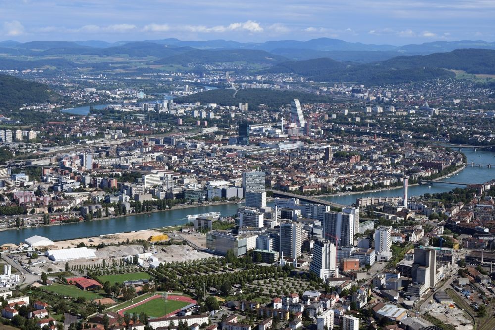 Basel from the bird's eye view: City area on the banks of river Rhine at Novartis Campus in Basel, Switzerland, and (left) the tends of the remediation area ARA Steih in Huningue, France