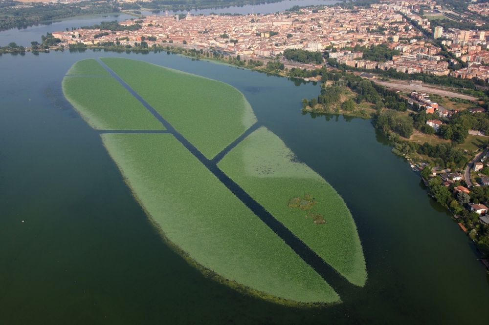 Mantua from the bird's eye view: City view of the downtown area on the shore areas of lago superiore, in the district Angeli in Mantua in Lombardy, Italy. In front of it in the lake a large field of water lilies and lotus plants