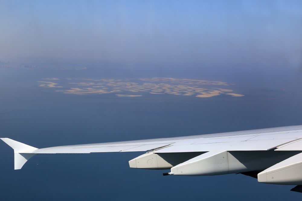 Aerial image Dubai - Take off of an Airbus A 380 and view to the Island Group The World in the Persian Gulf at the coast of Dubai, United Arab Emirates