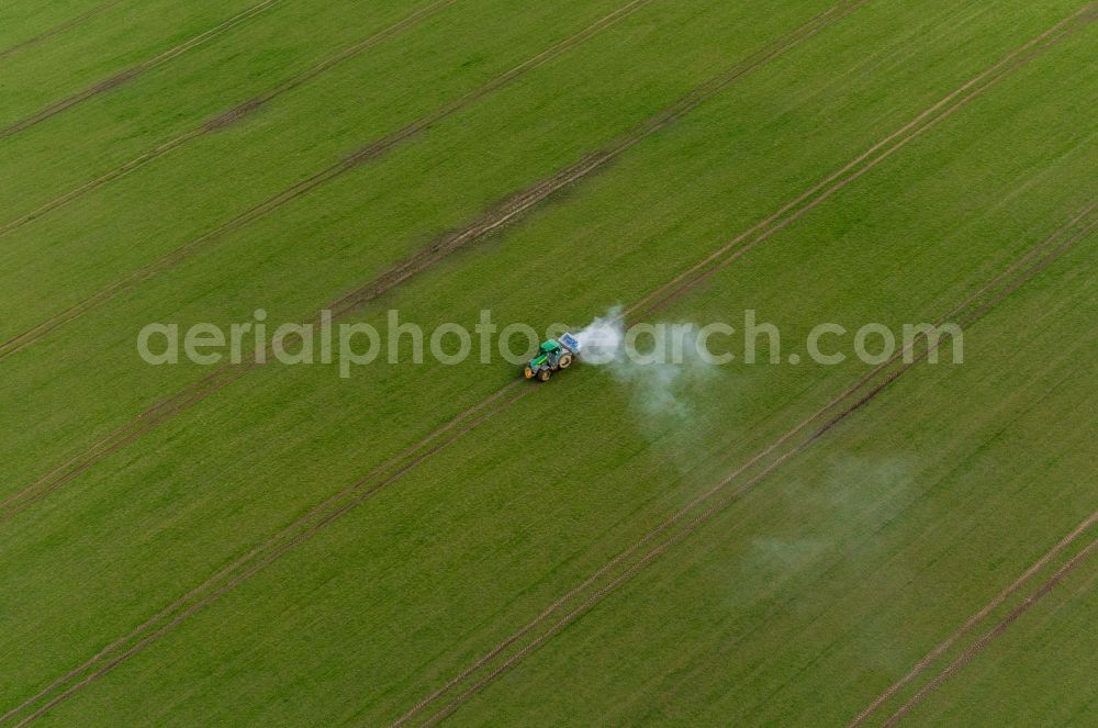Gammelin from above - Spraying of lime as fertilizer with tractor and special attachment on agricultural fields in Gammelin in the state Mecklenburg - Western Pomerania, Germany
