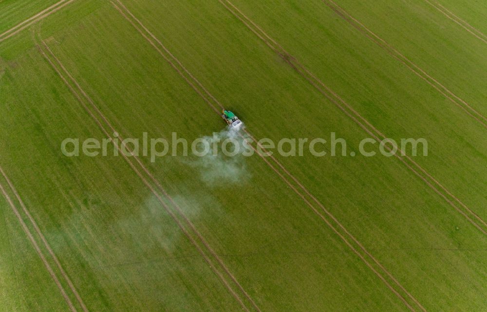 Gammelin from above - Spraying of lime as fertilizer with tractor and special attachment on agricultural fields in Gammelin in the state Mecklenburg - Western Pomerania, Germany
