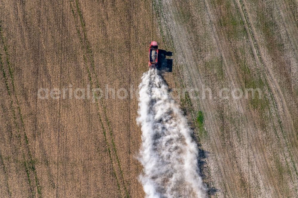 Aerial image Trebnitz - Spraying of lime as fertilizer with tractor and special attachment on agricultural fields in Trebnitz in the state Saxony-Anhalt, Germany