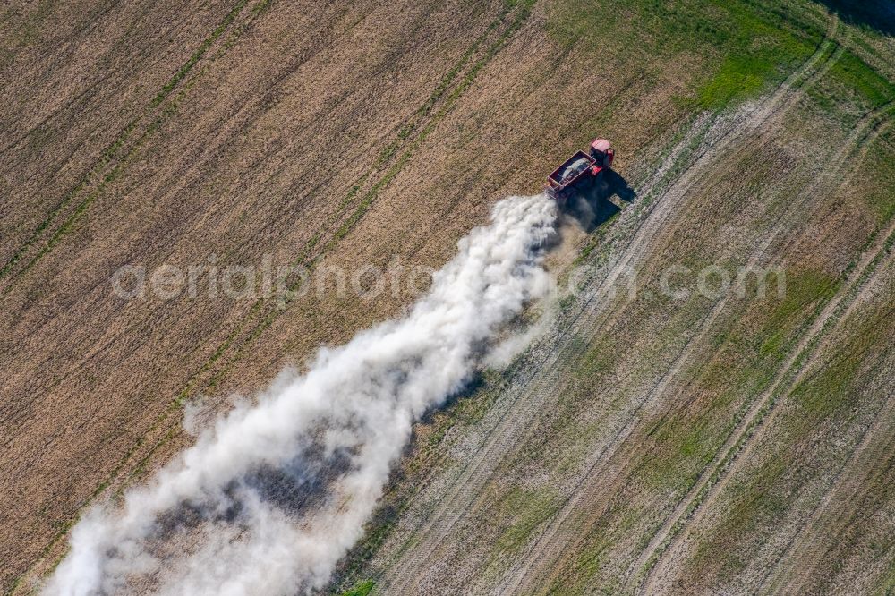 Aerial photograph Trebnitz - Spraying of lime as fertilizer with tractor and special attachment on agricultural fields in Trebnitz in the state Saxony-Anhalt, Germany