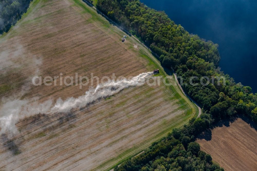 Trebnitz from above - Spraying of lime as fertilizer with tractor and special attachment on agricultural fields in Trebnitz in the state Saxony-Anhalt, Germany