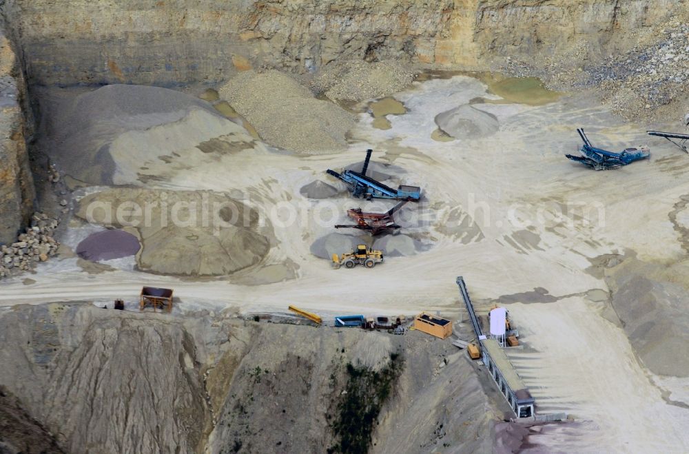 Gutendorf from above - View of the guarry of limestone in Gutendorf with two quarry machines in the state of Thuringia. The limestone quarry is operated by the MKW Mitteldeutsche Hartstein- Kies- und Mischwerke GmbH