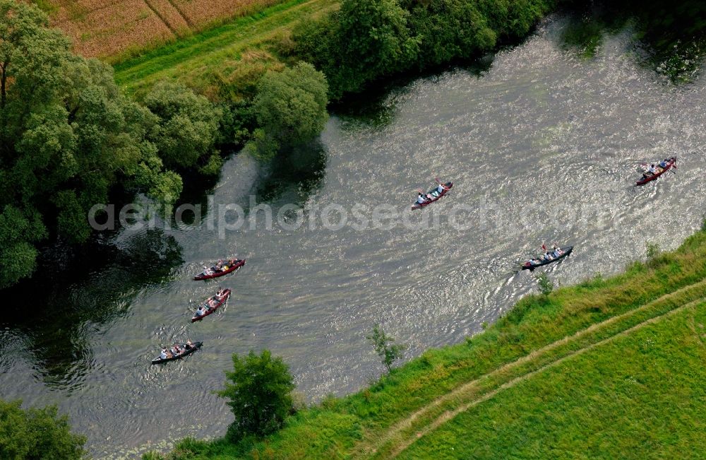 Marburg from the bird's eye view: Canoes on the river Lahn in Marburg in the state of Hesse. The group of boats moves along a narrow passage of the long river near Marburg, where fields and forest are located on the riverbank