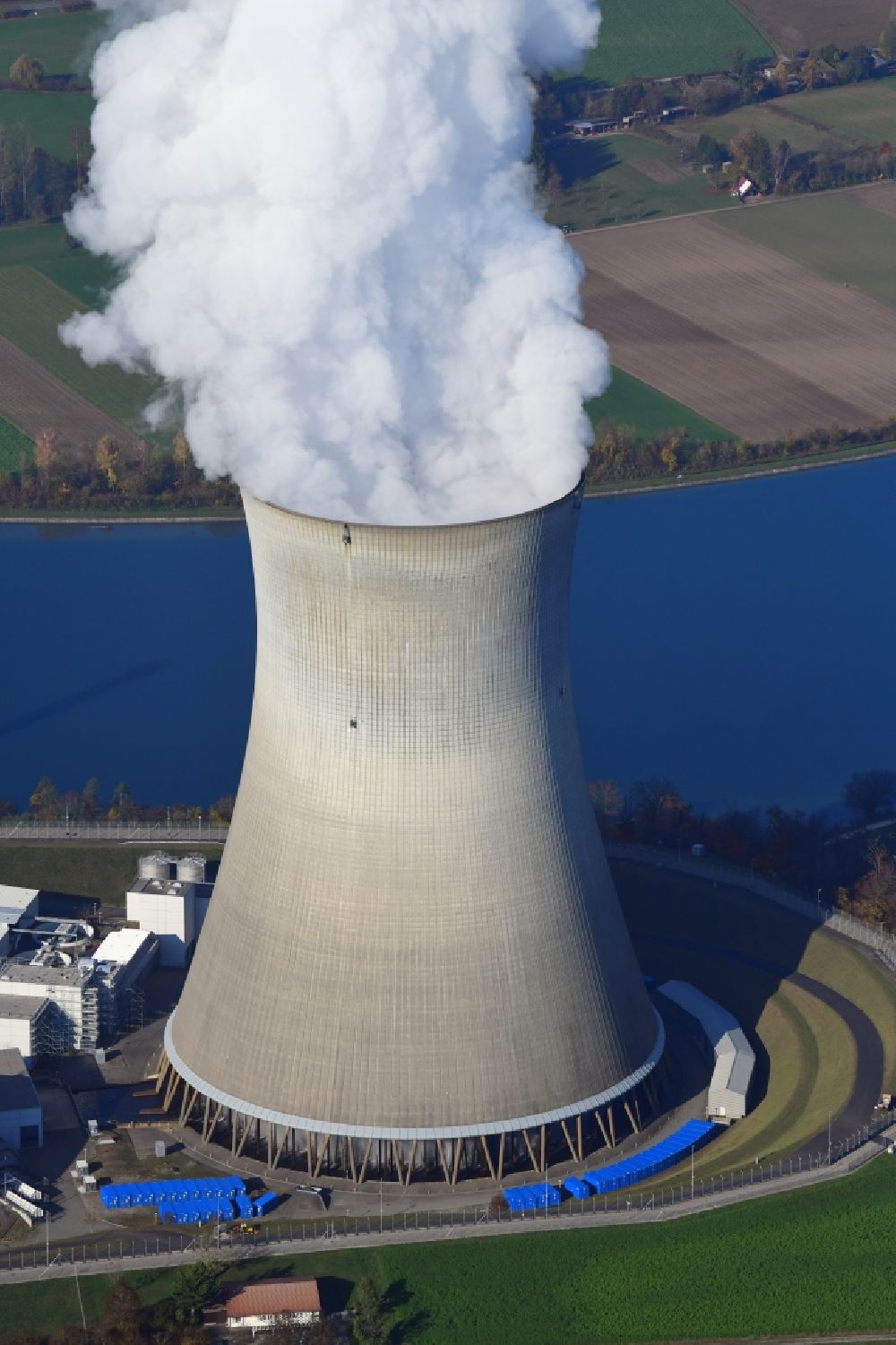 Leibstadt from the bird's eye view: Cooling tower and steam cloud at the NPP nuclear power plant Leibstadt KKL on the Rhine river in Leibstadt in the canton Aargau, Switzerland