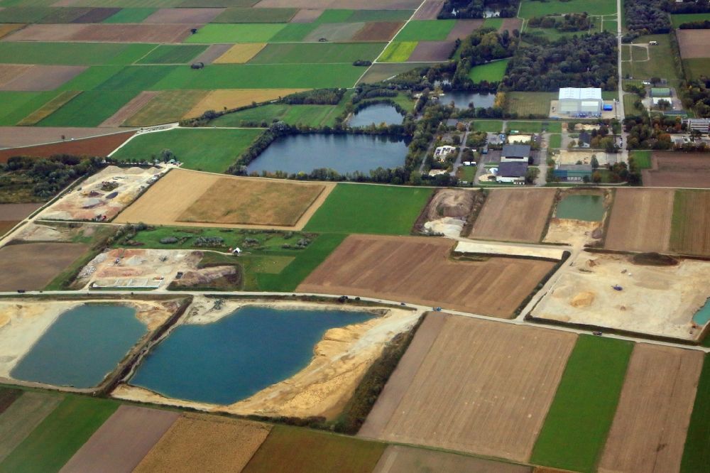 Erding from above - Site and tailings area of gravel mining with quarry ponds at the Wartenberger street in Erding in the state Bavaria, Germany
