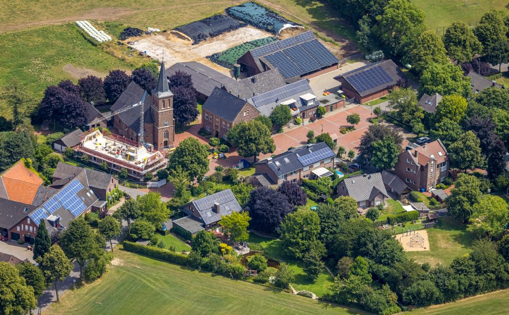 Aerial photograph Hamminkeln - Church building St. Antonius with a construction site on street Antoniusstrasse in Hamminkeln in the state North Rhine-Westphalia, Germany