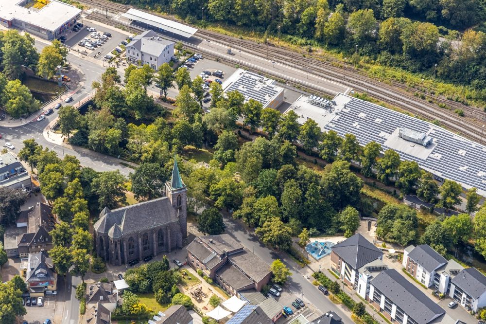 Menden (Sauerland) from above - Church building of the Heilig-Geist-Kirche at the industrial area along the course of the river Henne on the streets Untere Promenade and Bodelschwinghstrasse in Menden (Sauerland) in the state North Rhine-Westphalia, Germany