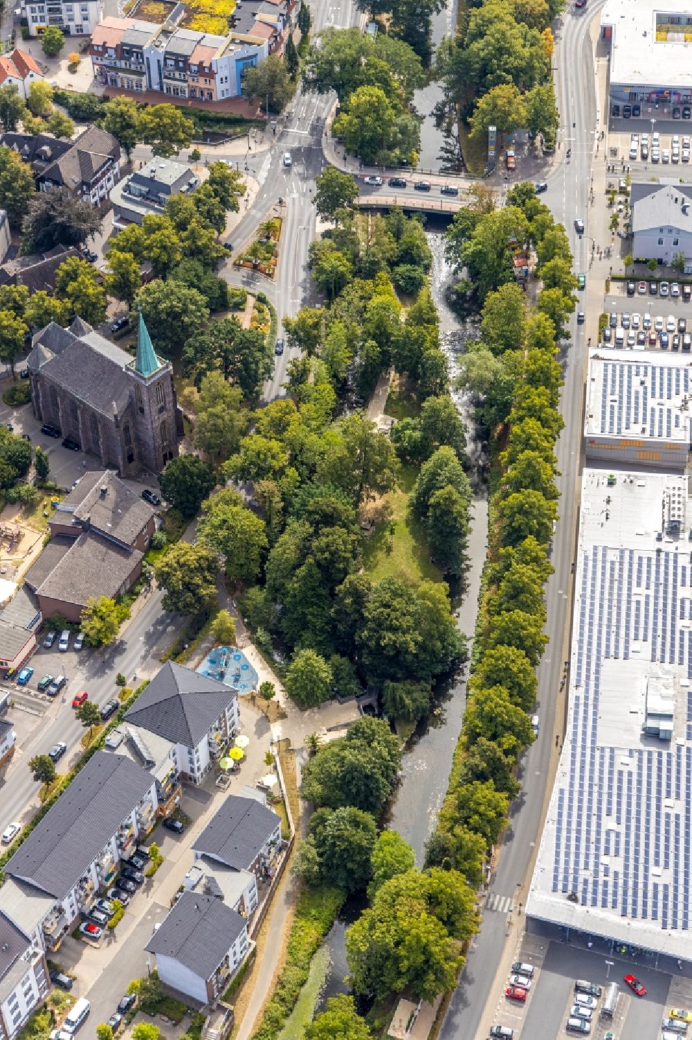 Aerial image Menden (Sauerland) - Church building of the Heilig-Geist-Kirche at the industrial area along the course of the river Henne on the streets Untere Promenade and Bodelschwinghstrasse in Menden (Sauerland) in the state North Rhine-Westphalia, Germany