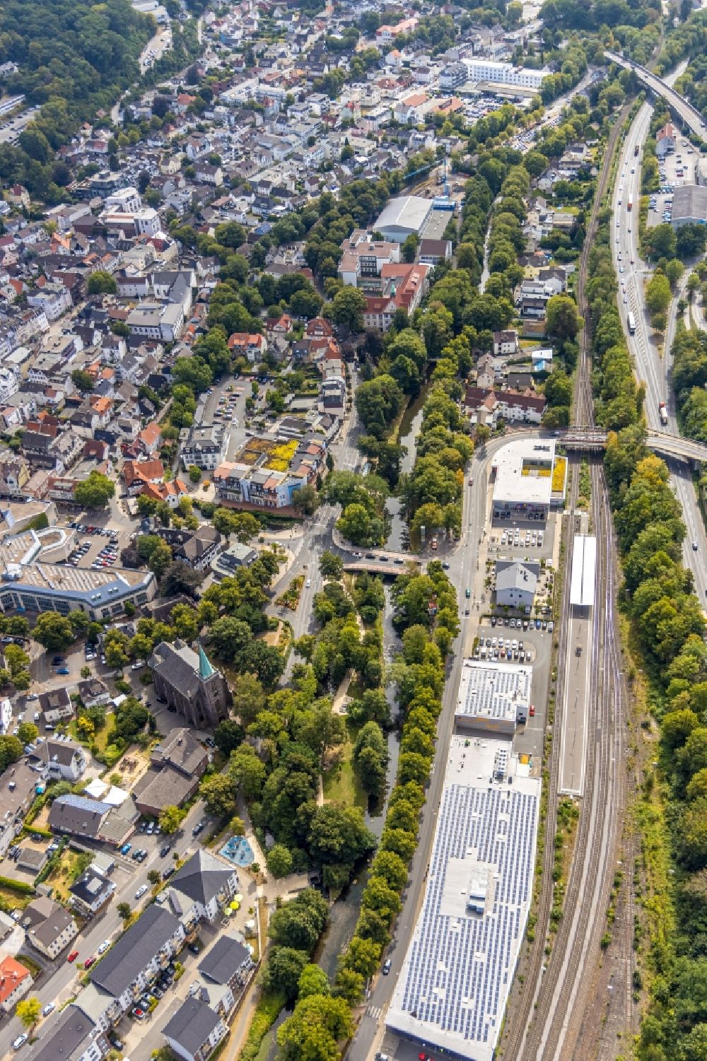 Aerial photograph Menden (Sauerland) - Church building of the Heilig-Geist-Kirche at the industrial area along the course of the river Henne on the streets Untere Promenade and Bodelschwinghstrasse in Menden (Sauerland) in the state North Rhine-Westphalia, Germany