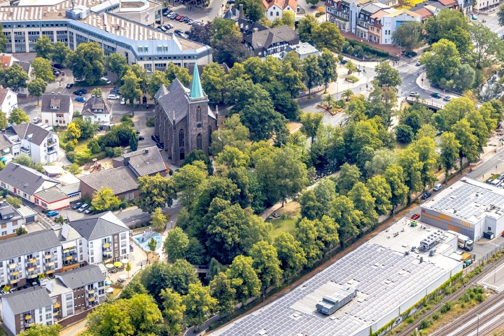 Menden (Sauerland) from above - Church building of the Heilig-Geist-Kirche at the industrial area along the course of the river Henne on the streets Untere Promenade and Bodelschwinghstrasse in Menden (Sauerland) in the state North Rhine-Westphalia, Germany