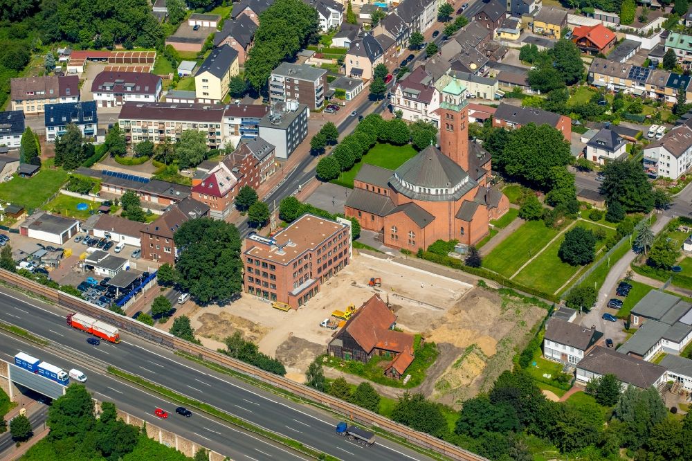 Aerial image Gladbeck - Church building of the Catholic Parish of the Holy Cross in Gladbeck in North Rhine-Westphalia. The focus of the new building of the family doctor center Butendorf at the Horster street