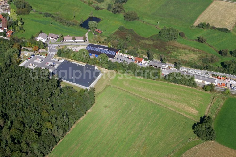 Aerial photograph Schöllnach - Small company settlement with a branch of the supermarket Rewe on Bahnhofstrasse in the southeast of Schoellnach in the state Bavaria, Germany