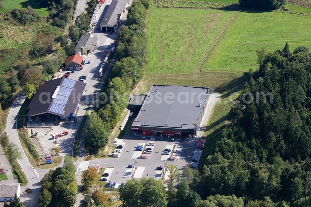 Aerial image Schöllnach - Small company settlement with a branch of the supermarket Rewe on Bahnhofstrasse in the southeast of Schoellnach in the state Bavaria, Germany