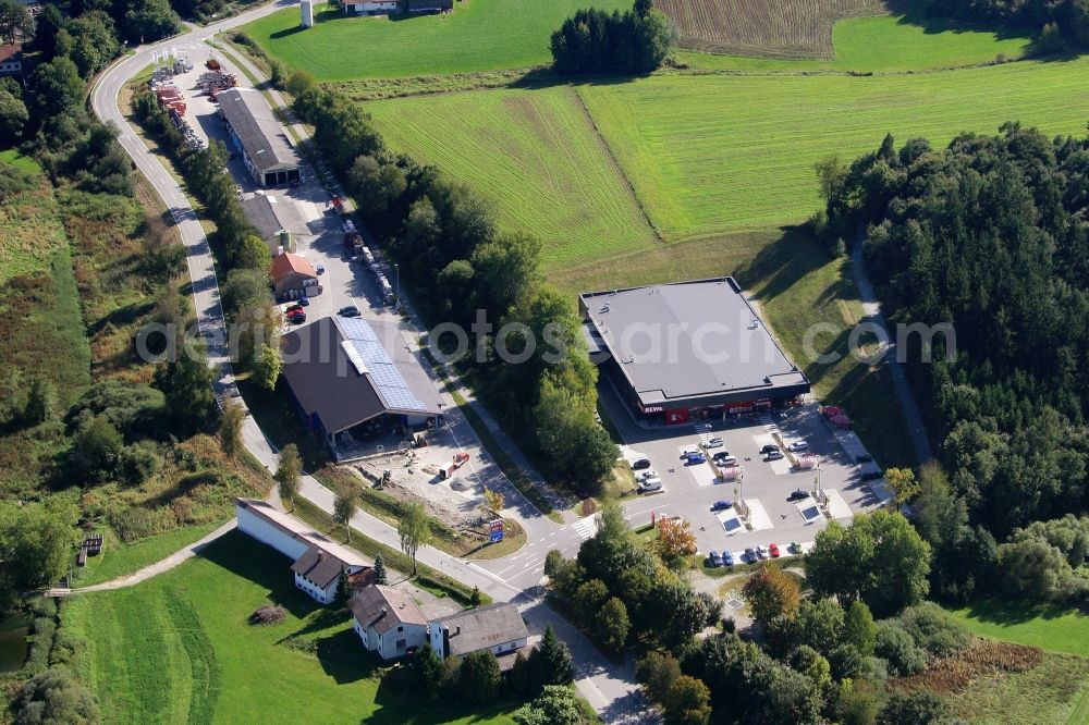 Schöllnach from above - Small company settlement with a branch of the supermarket Rewe on Bahnhofstrasse in the southeast of Schoellnach in the state Bavaria, Germany