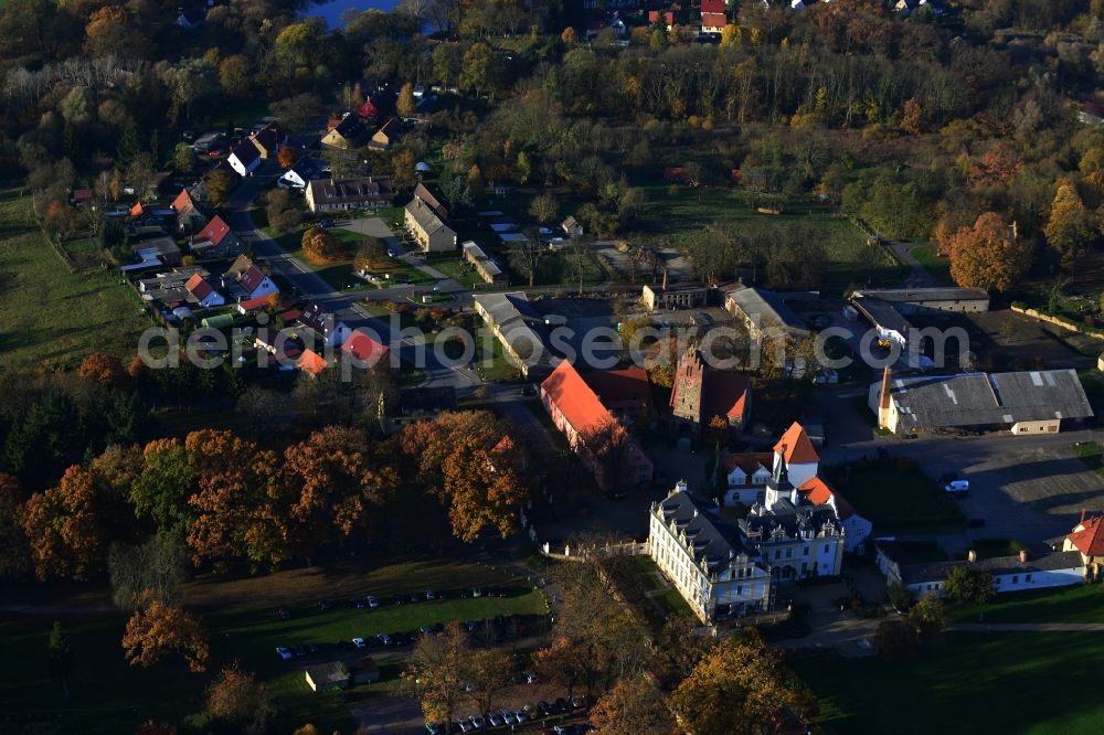 Aerial image Löwenberger Land Liebenberg - Small village at the Weissen See along the Bergsdorfer Strasse. Historic manor Schloss & Gut Liebenberg with castle, manor house, stone church DKB Stiftung Liebenberg gemeinnuetzige GmbH. The palace and its grounds now serves as a hotel and venue. The village is surrounded by forest and field areas in the district Liebenberg in Loewenberger Land in the state of Brandenburg