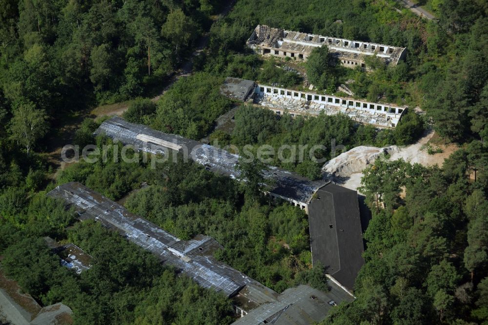 Aerial photograph Bad Düben - Hospital grounds of the old Waldkrankenhaus in Bad Dueben in the state of Saxony. The historic semi-circular and partly decayed compound with its elongated buildings is located in a forest in the North of the town and used to be known as a specialised orthopaedics clinic in the GDR