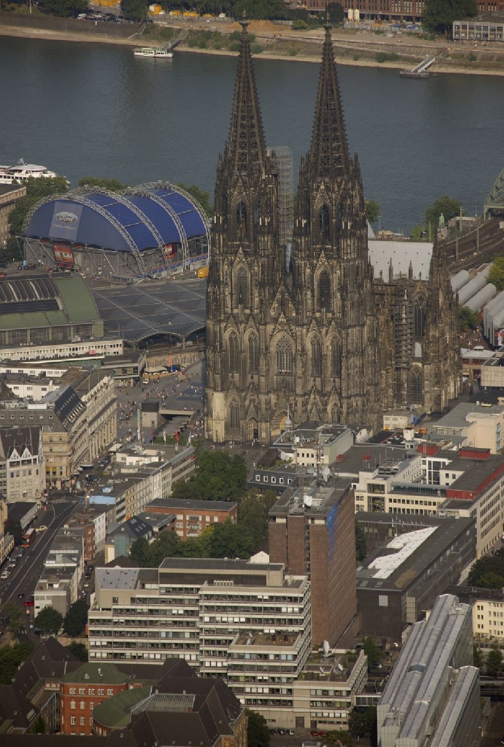 Köln from the bird's eye view: View of the Cologne Cathedral in the center of Cologne, near central station. The Cologne Cathedral is a Roman Catholic church in the Gothic style in Cologne and the Cathedral of the Archdiocese of Cologne. It is the second highest church building in Europe and the third highest in the world