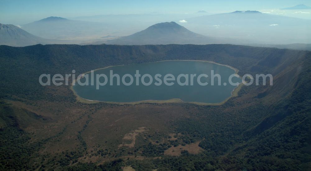 Aerial image Engaruka - Blick auf den Kratersee des Empakai im Ngorongoro-Naturschutzgebiet in Tansania. Der Vulkan ist 2.700 m hoch und die Kraterwände erreichen bis zu 600 m Höhe. View of the crater lake of the Empakai in the Ngorongoro Conservation Areal Park in Tanzania. The volcano is 2,700 m high and the crater walls rise up to 600 meters.