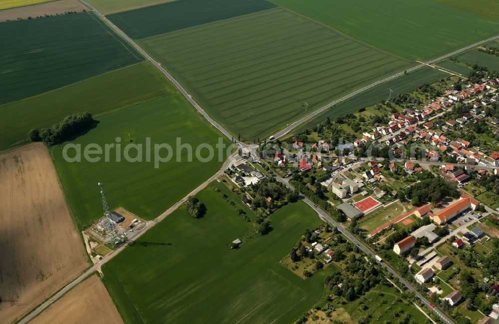 Ebeleben from above - Traffic management of the roundabout road of B249 and of Rockstedter Strasse with agricultural land and field borders surrounding the settlement area of the village in Ebeleben in the state Thuringia, Germany