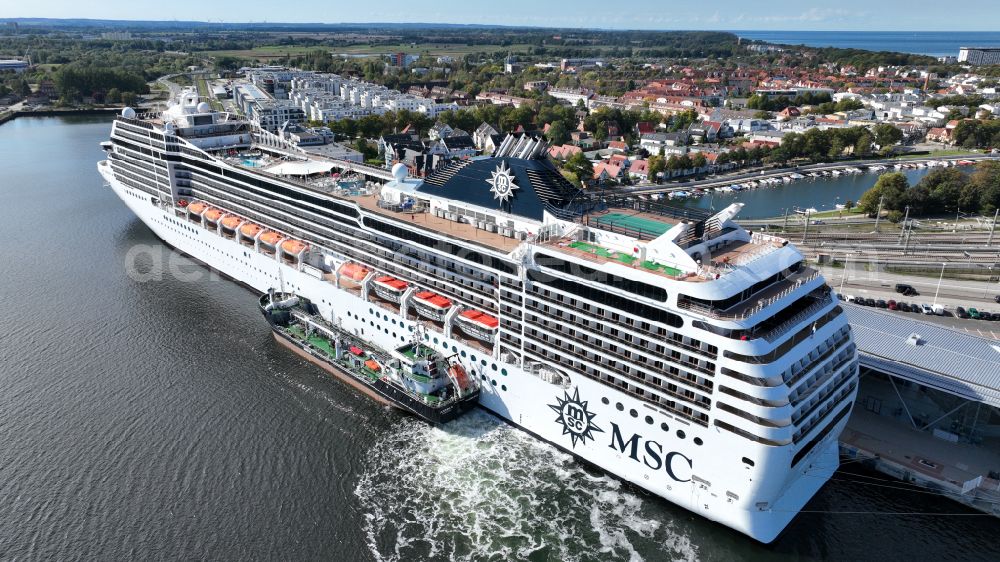 Aerial image Rostock - Cruise and passenger ship MSC Poesia in mission of baltic sea in the district Warnemuende in Rostock at the baltic sea coast in the state Mecklenburg - Western Pomerania, Germany