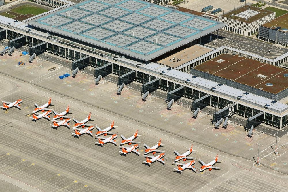 Aerial photograph Schönefeld - Decommissioned due to crisis passenger airplanes of the airline easyJet in parking position - parking area at the airport in Schoenefeld in the state Brandenburg, Germany