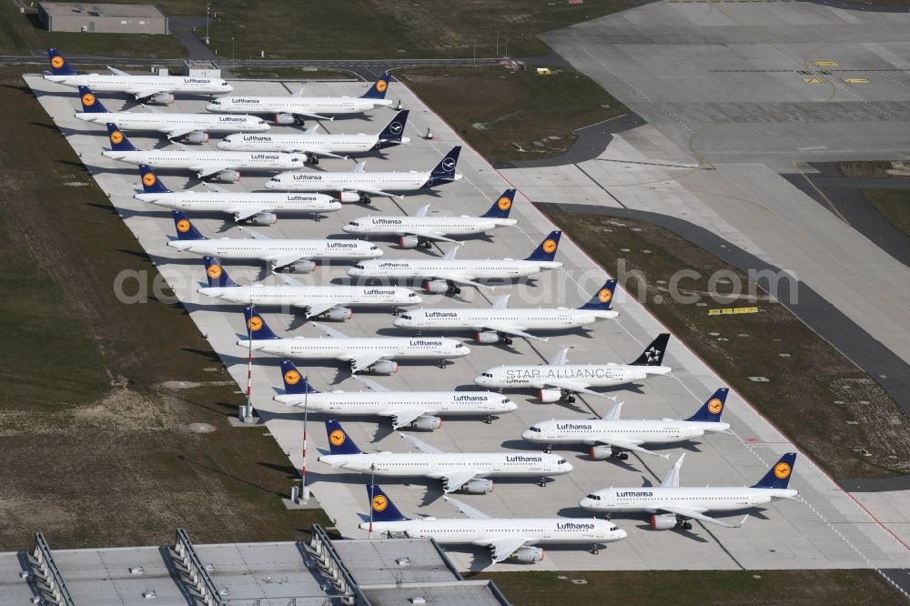 Aerial image Schönefeld - Decommissioned due to crisis passenger airplanes of the airline Lufthansa in parking position - parking area at the airport in Schoenefeld in the state Brandenburg, Germany