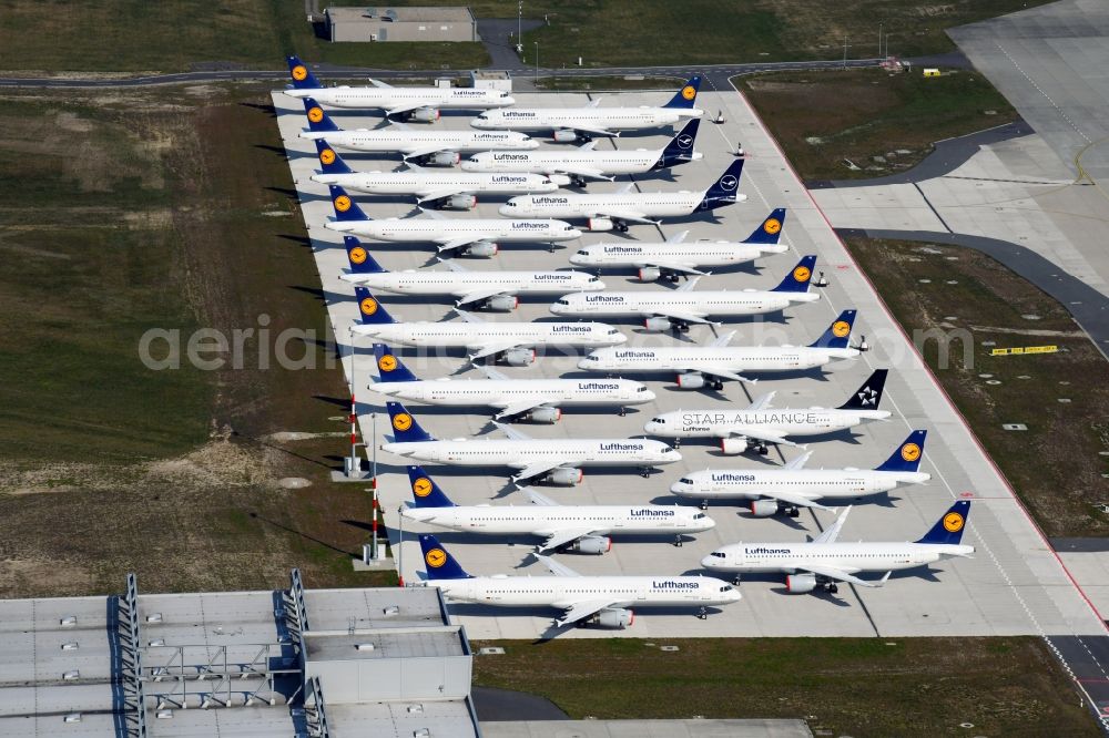 Schönefeld from above - Decommissioned due to crisis passenger airplanes of the airline Lufthansa in parking position - parking area at the airport in Schoenefeld in the state Brandenburg, Germany